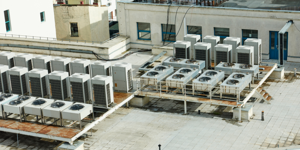 Rooftop view of commercial HVAC systems for energy efficiency in Phoenix, AZ. Condenser units on a flat roof, showcasing HVAC equipment.