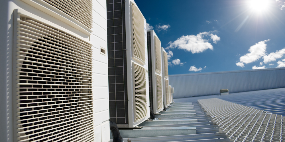 HVAC units on a rooftop under a blue sky. Residential HVAC Installation and Maintenance in Peoria, AZ. Air conditioning system.