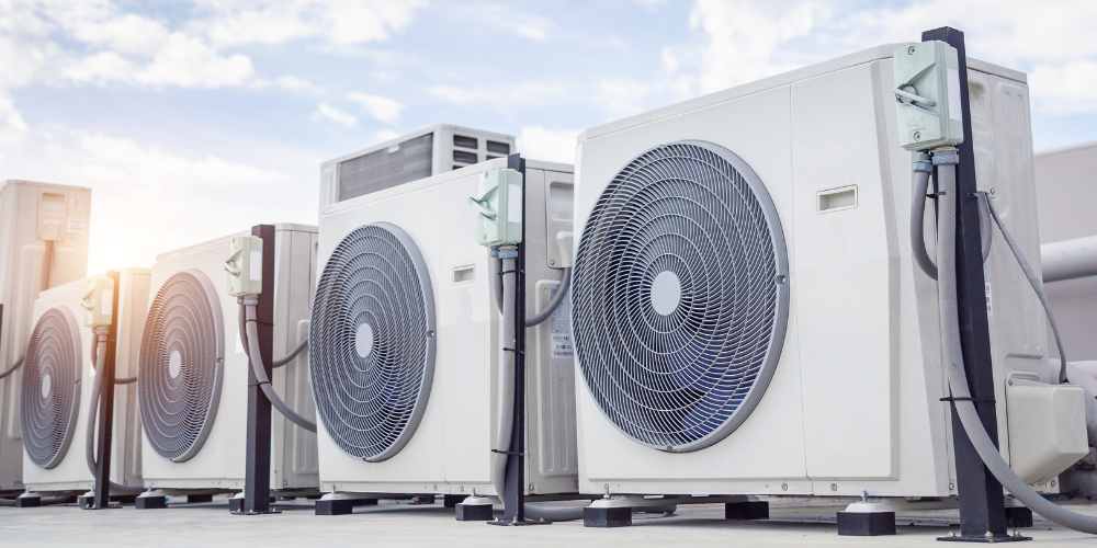 HVAC Cooling Systems: Row of commercial air conditioning units on a rooftop, maximizing energy efficiency in Phoenix, AZ.